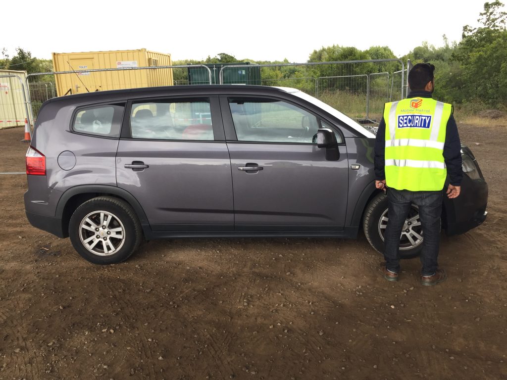 Shaz from Mobile Patrol Bristol with the patrol vehicle on a client site in Bristol